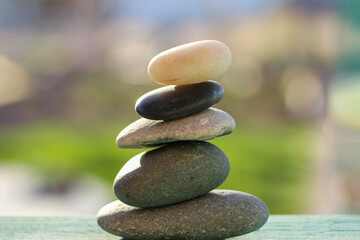 Natural wellness concept / Relax zen stones stack on wooden nature green background Spa Natural Alternative Therapy With Massage Stones