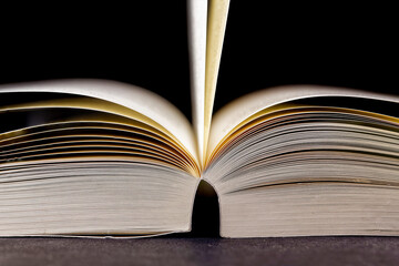 Open vintage book, focus on pages at the right side. black background