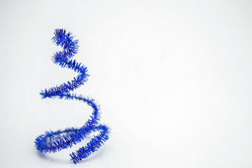 Christmas blue tinsel with stars. Isolated on a white background.