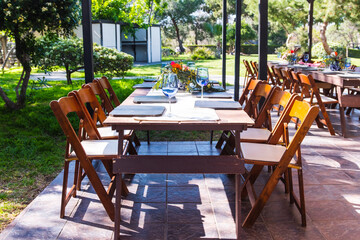 Country set table decoration with colorful flowers in a sunny day at park