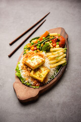 Paneer Sizzler is an Indian version with cottage cheese, salad served sizzling on hot stone dish.