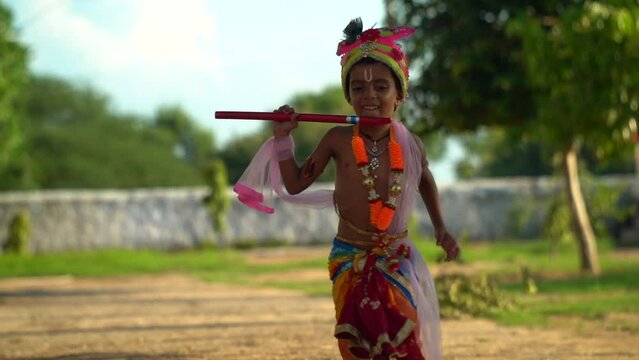 Lord Krishna running in the ground on Happy Janmashtami holiday Indian festival greeting background