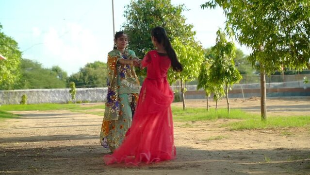 Dancing Rajasthani girl doing Ghoomer Kachhi ghodi dance. Beautiful indian girl dancer in the posture of Indian dance.