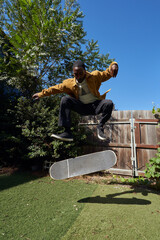 Portrait of young non-binary doing flip tricks on skateboard   © Sheilby Macena