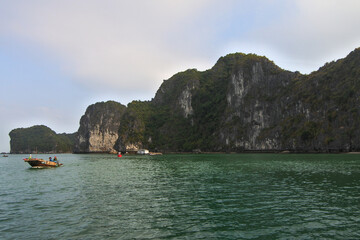 Naklejka premium One day tour with traditional Vietnam boat in Cat Ba island. Cat Ba is one of popular tourist attraction beside Ha Long Bay in Vietnam.