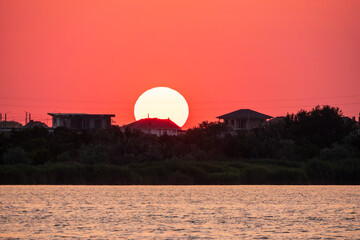 The sun goes down over a lake