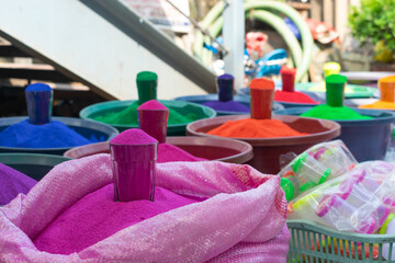 Vibrant colors, rangoli, dyes glass filled  in tub on street for sale during festivals of Holi, Diwali. Design colorful, lakshmi pooja, worship, symbolize, prosperity, handmade, organic, home entrance