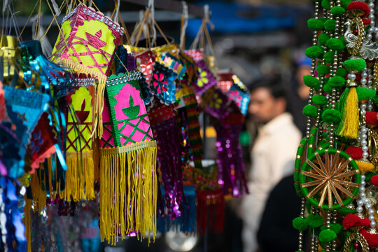 Small colorful Diwali lanterns, toran hanging at a stall, shop for sale. Modern, traditional, light, bright,  size, shape, akash kandil, decorative lamps, market, home decor,  festival, celebration.