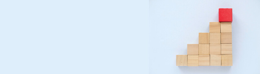 Steps of wooden cube with a red cube on top. Business concept for growth success process.  Banner with copy space.