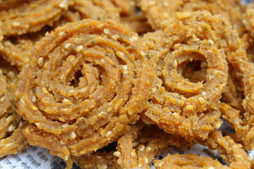 Indian Traditional Tea Time Snack Chakli, a deep fried snack, It is known as Chakali, Murukku, Muruku, Murkoo, Chakri. Chakali closeup 