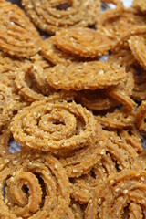 Indian Traditional Tea Time Snack Chakli, a deep fried snack, It is known as Chakali, Murukku, Muruku, Murkoo, Chakri. Chakali closeup 