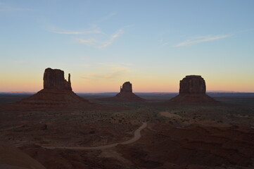 Fototapeta na wymiar Sunset over the East and West Mitten Buttes at Monument Valley, Utah
