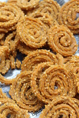 Indian Traditional Tea Time Snack Chakli, a deep fried snack, It is known as Chakali, Murukku, Muruku, Murkoo, Chakri. Chakali closeup 
