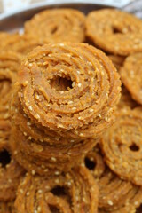 Indian Traditional Tea Time Snack Chakli, a deep fried snack, It is known as Chakali, Murukku, Muruku, Murkoo, Chakri. Chakali closeup 