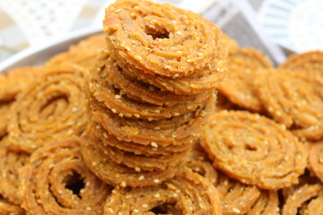 Indian Traditional Tea Time Snack Chakli, a deep fried snack, It is known as Chakali, Murukku, Muruku, Murkoo, Chakri. Chakali closeup 