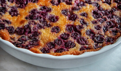 White ceramic baking dish with freshly baked cherry pie CLAFUTI, close-up