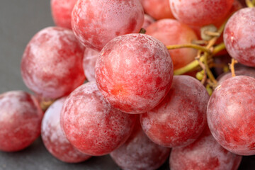 Harvest of ripe, juicy, red grapes with large berries close-up