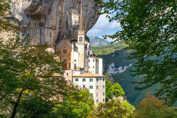 View from the mountain hiking trail of the Santuario de la Madonna della Corona, a picturesque historic mountainside church built in 1625 in Spiazzi, Italy.	