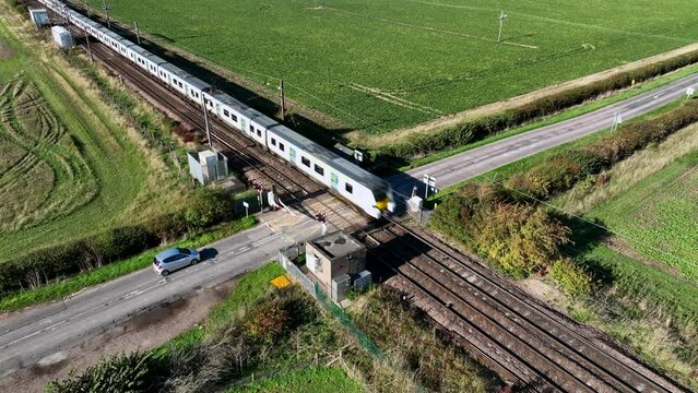 Fast Commuter Train Passing Over a Level Crossing
