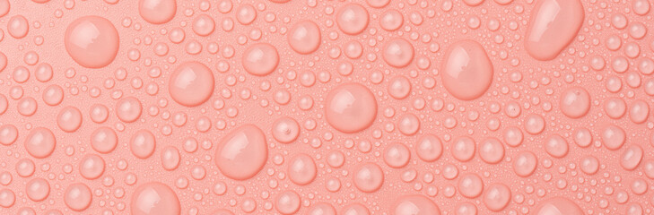 Water drops on a pink background close-up