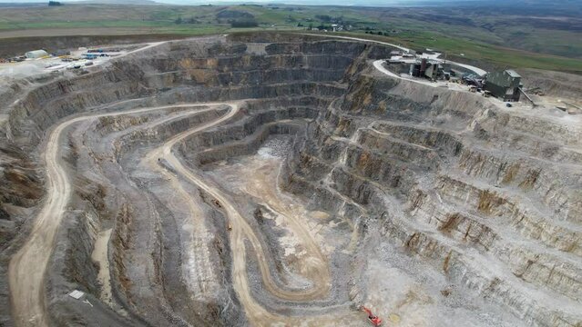 Aerial drone forward moving shot over Hanson Aggregates Quarry site in Harrogate, North Yorkshire, England, UK at daytime.