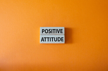 Positive attitude symbol. Concept words Positive attitude on wooden blocks. Beautiful orange background. Business and Positive attitude concept. Copy space.