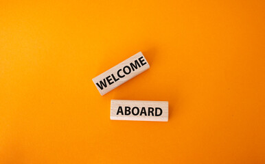 Welcome aboard symbol. Concept word Welcome aboard on wooden blocks. Beautiful orange background. Business and Welcome aboard concept. Copy space