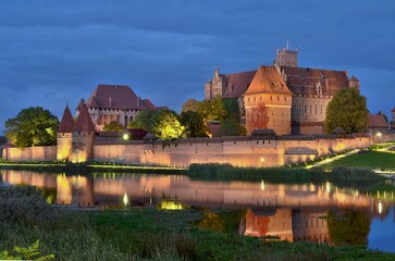 Naklejka na ściany i meble Castle of the Teutonic Order in Malbork by night 2022