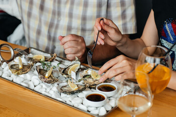Fresh oysters with lemon. raw opened oyster, lifestyle food, ready to eat. Oyster dinner with champagne in restaurant