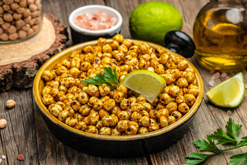 Roasted spicy chickpea or Indian chana or chole with lime. Tasty vegetarian and vegan chickpea snack. Food recipe background. Close up