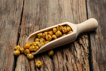 Roasted spicy chickpeas on wooden table background. banner, menu, recipe place for text, top view