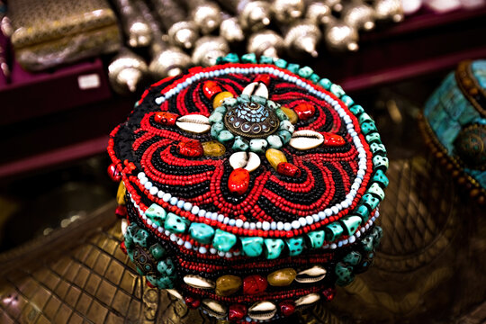 Vintage Middle Eastern woman's headwear decorated with gems on the traditional souk in Oman