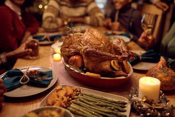 Close up of Thanksgiving turkey during family dinner at dining table.