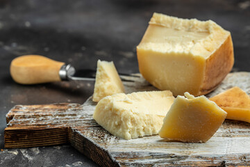 Traditional Gravyer Gruyere Cheese hard yellow cheese without holes, with a dark crust and a pleasant floral and nutty aroma, place for text, top view