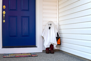 Ghost figure near the entrance door. Halloween decoration