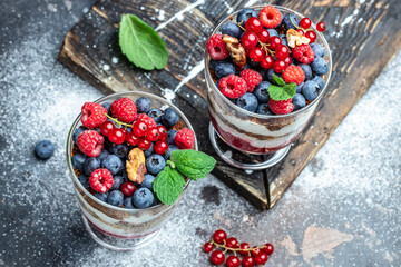 yogurt granola parfait with blueberry and raspberry on a dark background