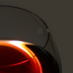 A glass of red wine on a gray background close-up.