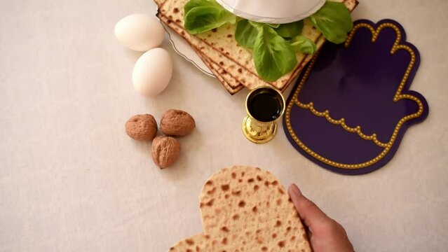 Woman's hands holds Matzah shape of heart. Traditional of Jewish Holiday on Passover. Home symbol of lovely family. top view, layout. love and care. Space for text.