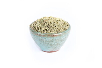 Fennel Seeds in Small Green Pottery Bowl in Side or Three Quarter View Shot Isolated on White
