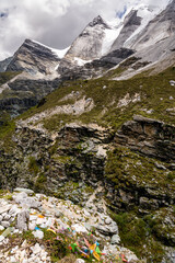 Beautiful panorama of colorful Tibetan praying flags, snow mountains at Yading nature reserve in summer season, The last Shangri la, Daocheng-Yading, Sichuan, China.