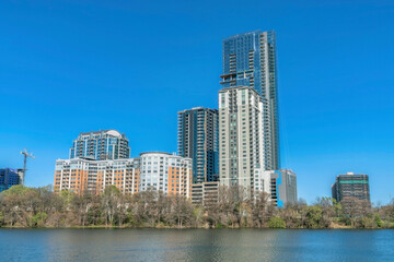 Fototapeta na wymiar Modern luxury apartments towering against blue sky with Colorado River view