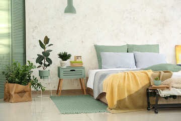 Stylish interior of bedroom with houseplants