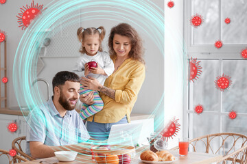 Happy young family having breakfast in kitchen. Concept of strong immunity