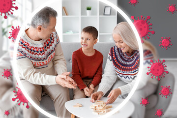 Little boy with his grandparents playing jenga game at home. Concept of strong immunity