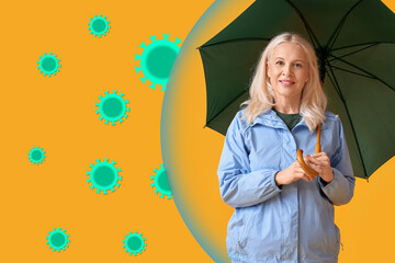 Mature woman with umbrella on yellow background. Concept of strong immunity