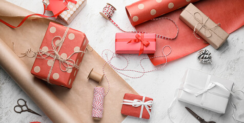 Beautiful gift boxes for Christmas and wrapping paper on light background, top view