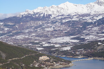 panoramic view from the top of the mountain of Serre Pon&ccedil;on lake in the Southern Alps, France with the old stone bridge in winter by the Bay de Chanteloupe