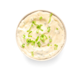 Bowl of tasty Caesar sauce with greens on white background