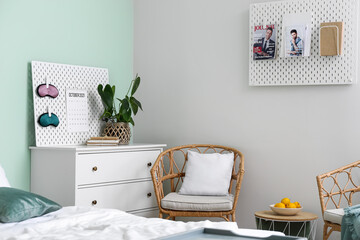 Pegboards with magazines and accessories in stylish bedroom
