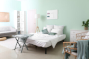Blurred view of light bedroom interior